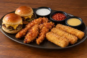 Illustrative appetizer platter with sliders, chicken strips, fried mozzarella and dipping sauces